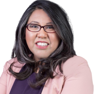 Headshot of Elvia Meza. She is wearing a light pink blazer and dark purple blouse.